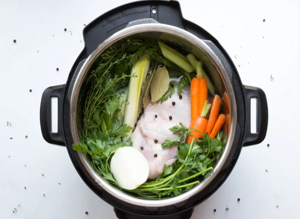 Ingredients to make chicken stock inside an Instant Pot Pressure Cooker.