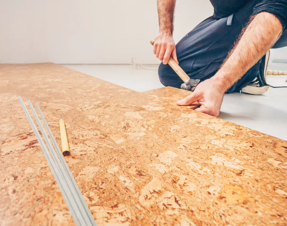 A man installing cork flooring.