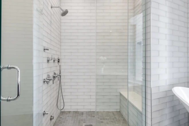 Custom shower with white tile and glass enclosure