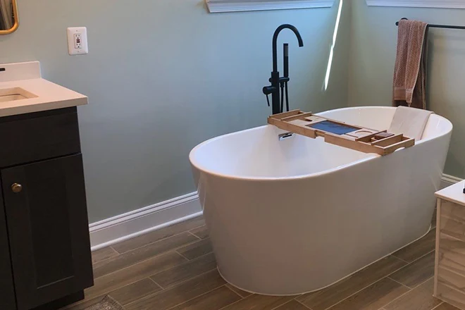 Freestanding bathtub next to glass frame shower