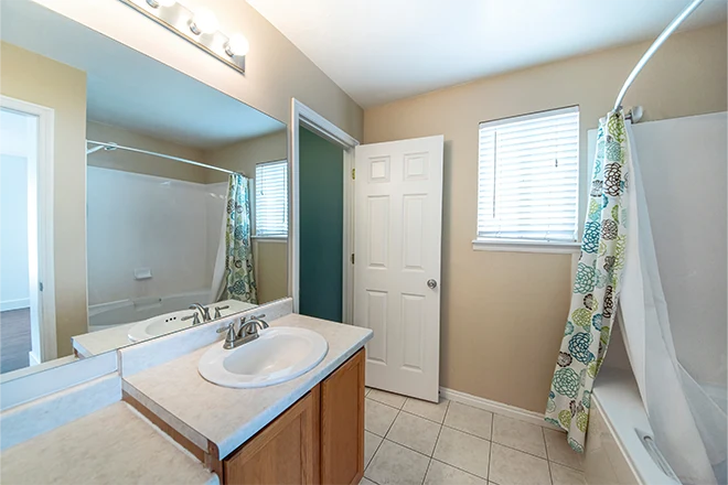Jack and Jill bathroom with ceramic tile flooring and window