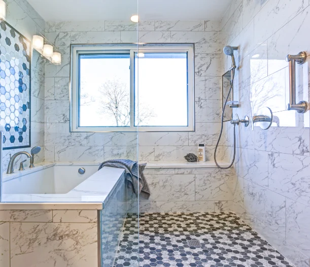 Large modern shower with bathtub and multiple tile types
