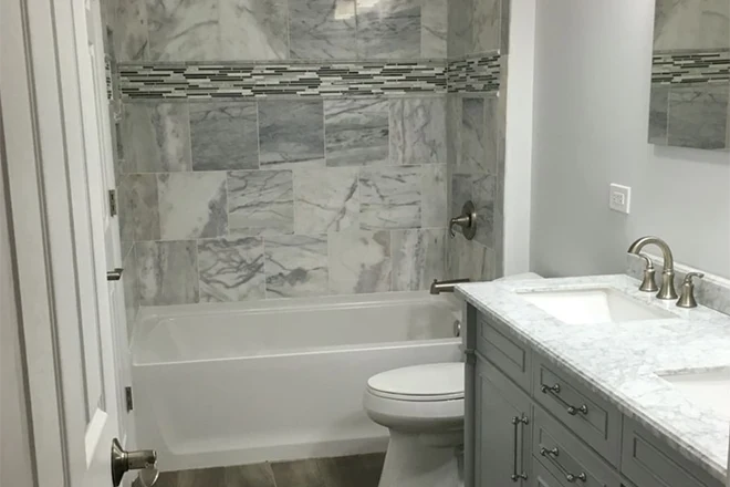 Bathtub shower with stone tile surround
