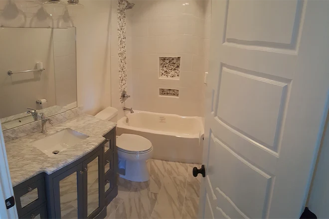 Smaller bathroom with built in tub and shower combination