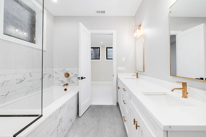 White bathroom with built in tub and attached shower