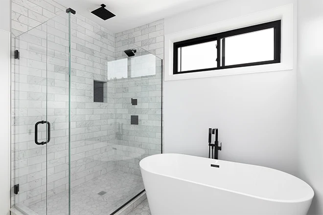 White freestanding tub with separate shower in white bathroom